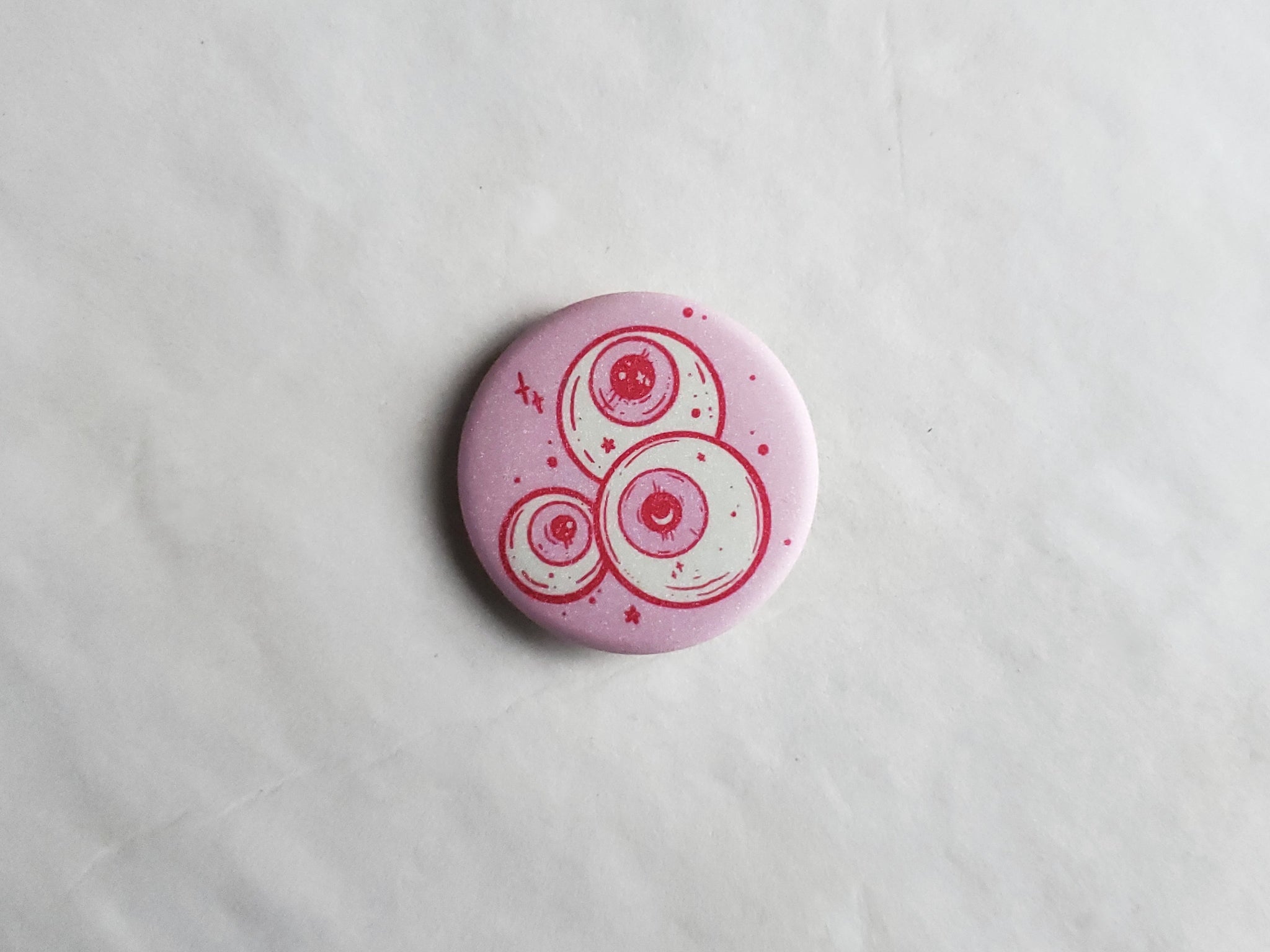 Pink Eyeballs pin badge